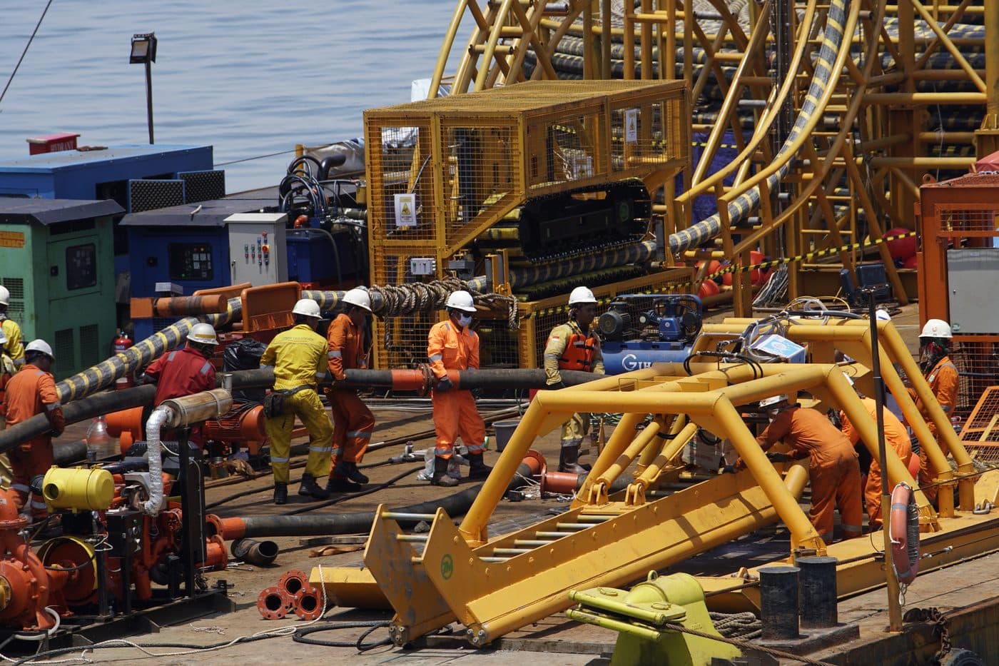 SGI crew carrying cable across the barge deck